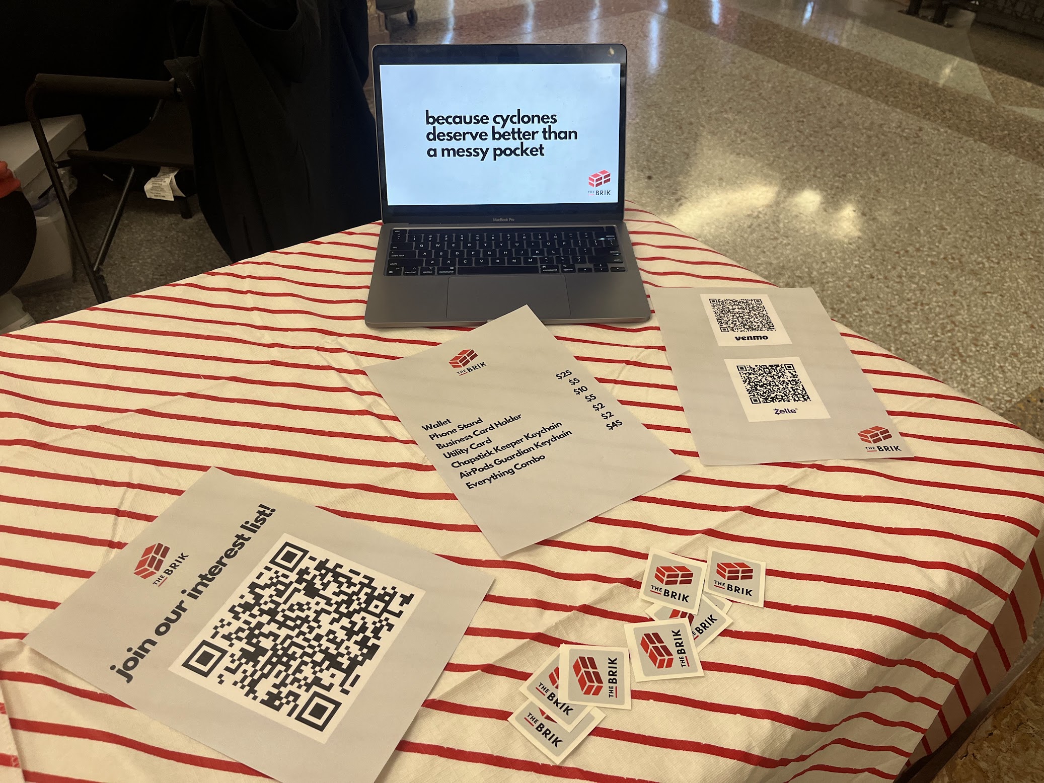 The Brik team showing the metal wallet at an event